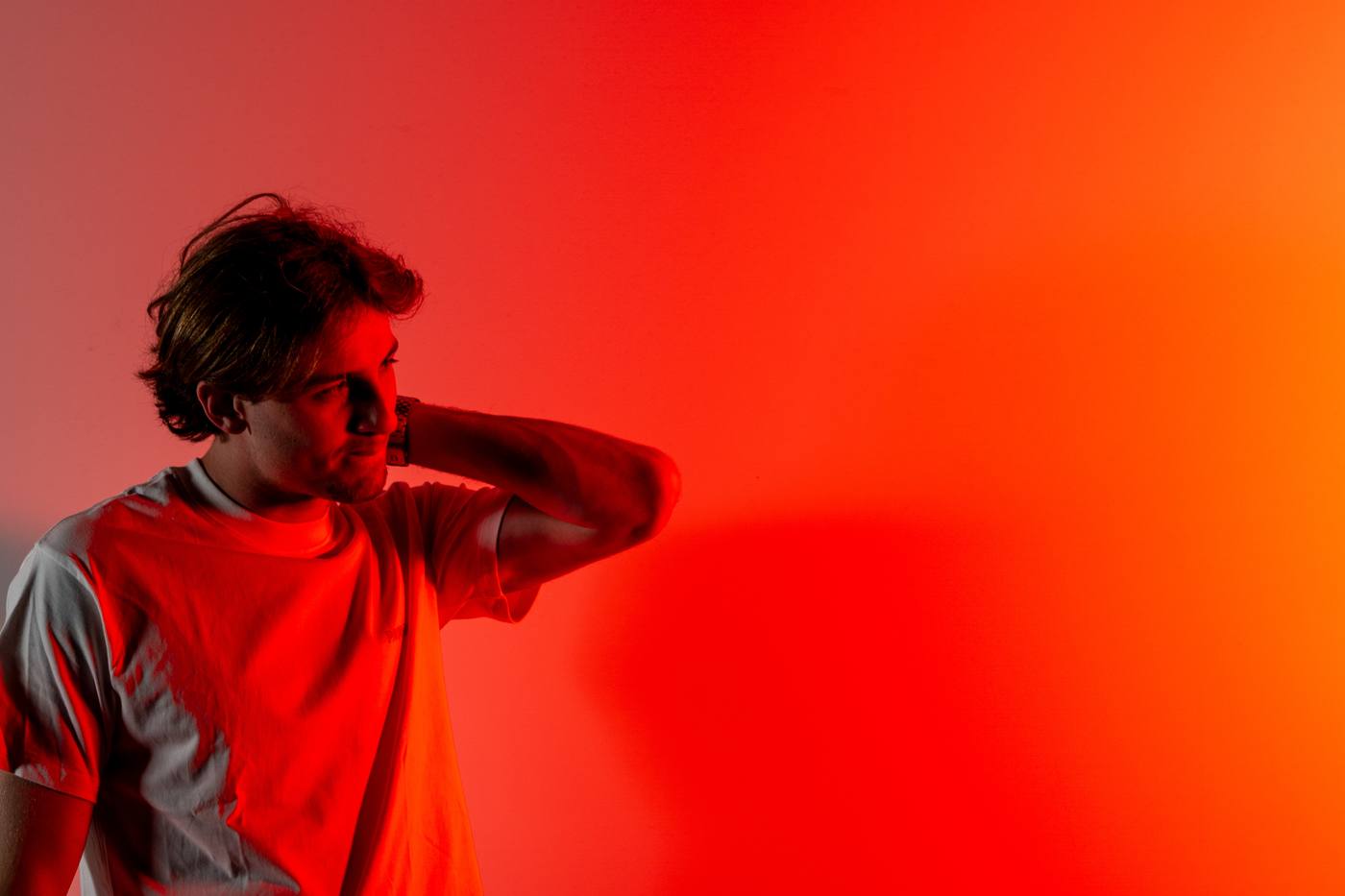 Jeune homme au casque, de profil, fond rouge et orange